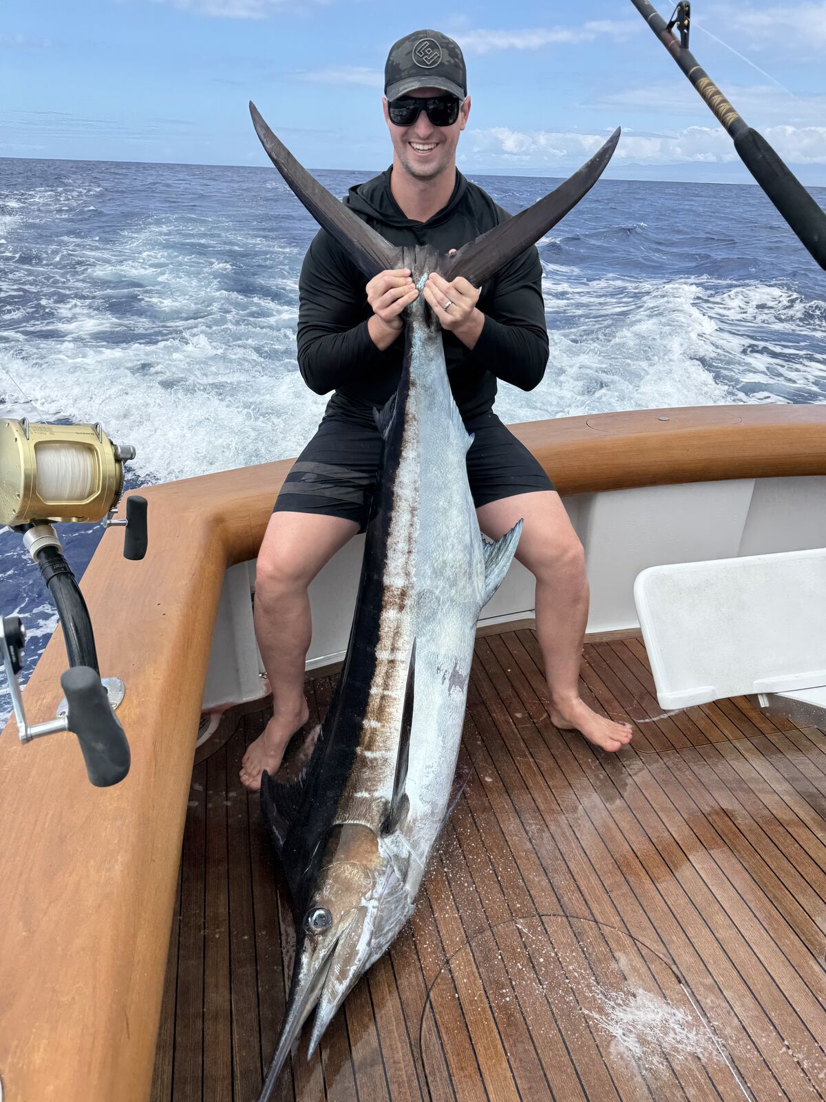 Angler with blue marlin on the teak deck